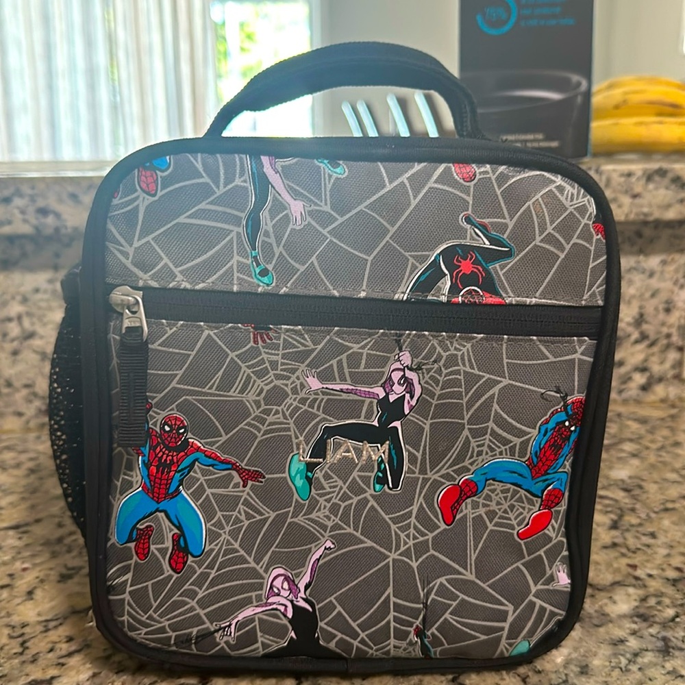 Pottery barn spiderman lunchbox. Name embroidered is “Liam”.